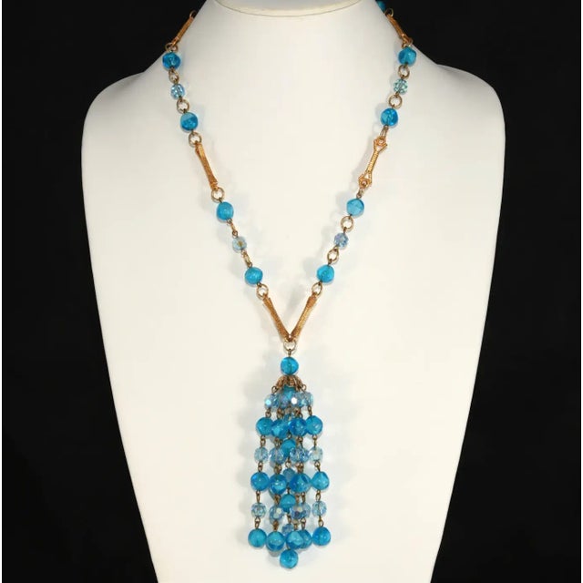 This is part of Chairish’s Costume Jewelry assortment. Vintage necklace with 4 1/2" tassel dangling from a chain made...