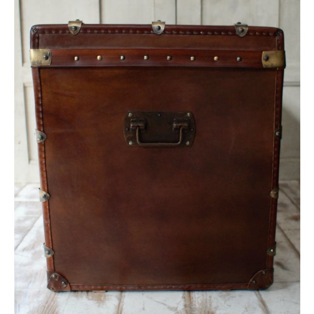 A superb maison armand bega steamer trunk. This steamer trunk features brown canvas, leather trim and brass work, lock and...