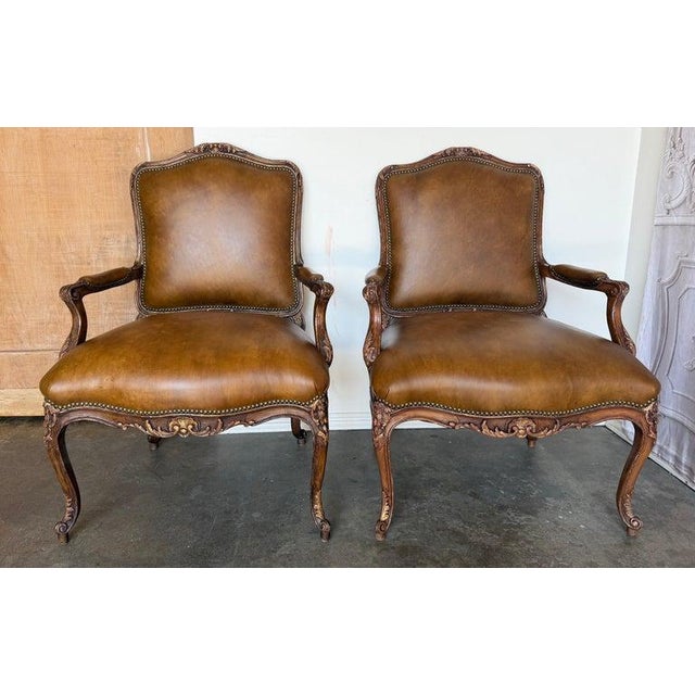 This perfectly matched pair of fauteils embodies the opulence and romance of 18th-century France. Each chair features the...