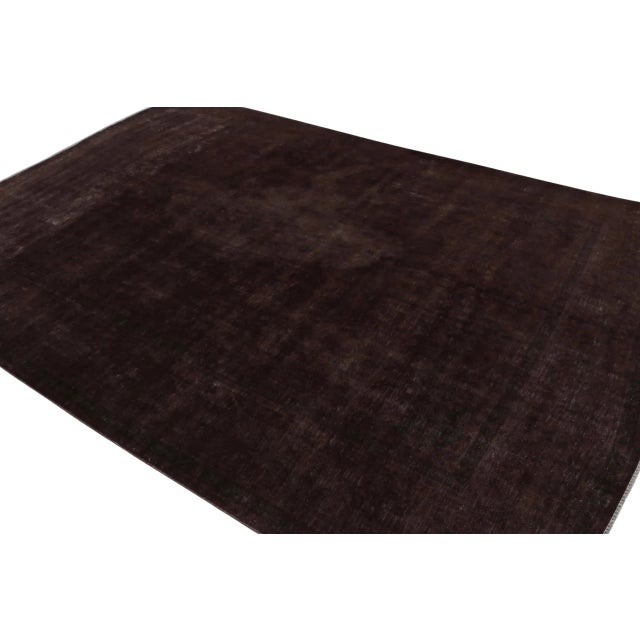 From our new collection of overdyed rugs, a vintage 9x13 Persian rug originating circa 1970-1980 or possibly earlier. On...