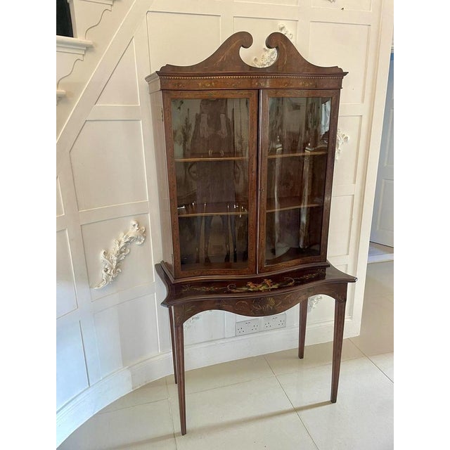 Antique Victorian quality mahogany display cabinet with original painted decoration having a swan neck pediment above a...