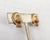 1960s goldtone bonnet with ribbons with faux-pearls around the raised section and enamel flower in the back clip earrings....