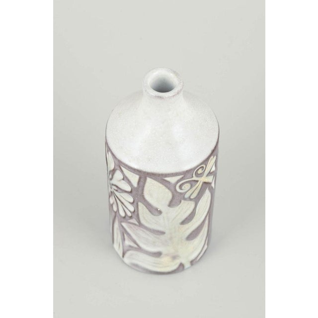 Mari Simmulson for Upsala Ekeby Vase, model 4330/683, 1960s. Relief-decorated cylindrical stoneware vase with stylised...