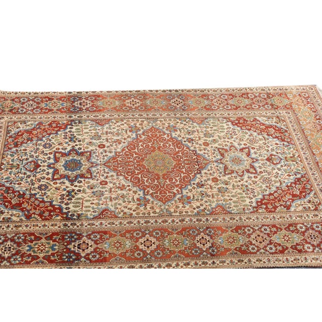 A lightly stepped red diamond medallion encloses dense ecru volutes, and suspends very unusual octogramme red pendants...