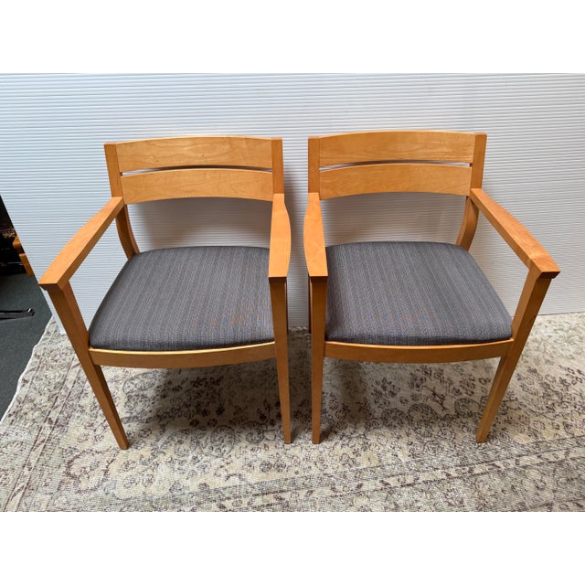 Design Plus Gallery presents a Pair of Contract Grade Armchairs from HBF Furniture. The pair of chairs have a honey maple...