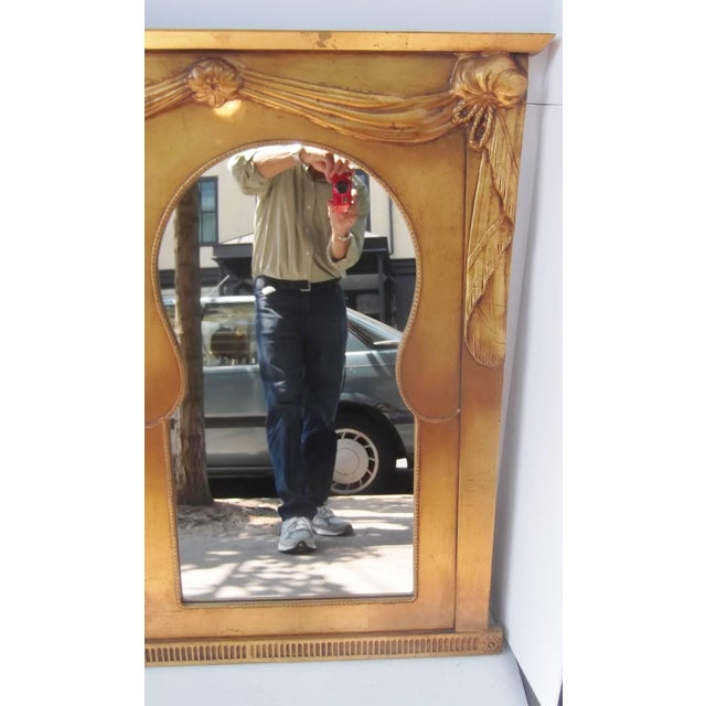 A very exotic and large-scale decorator mirror with giltwood frame. The mirror insets have a textured edging around each...