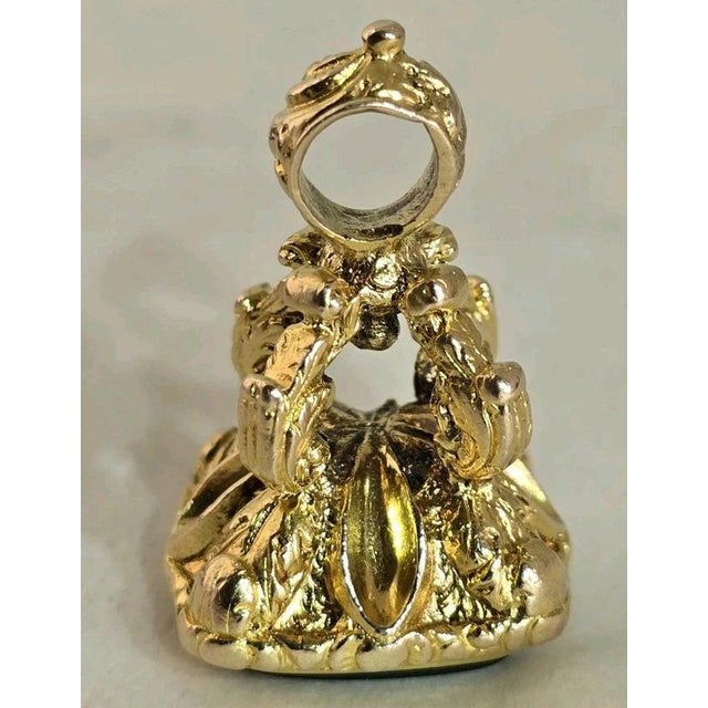 A distinctive vintage 9ct yellow gold novelty charm, fob or seal dating to 1970, displaying attractive traditional...
