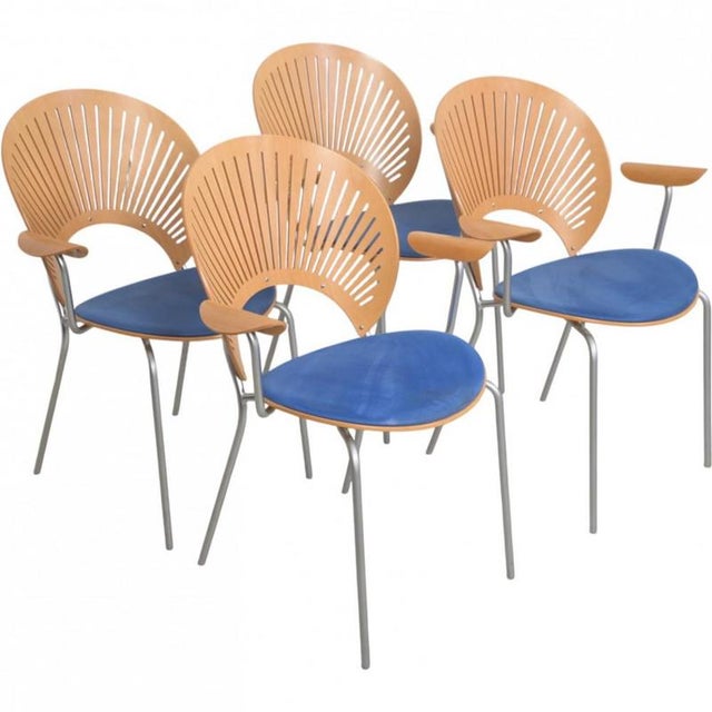 Set of 4 Nanna Ditzel Trinidad armchairs, made of beech and with the seat upholstered with blue fabric. The chairs are...