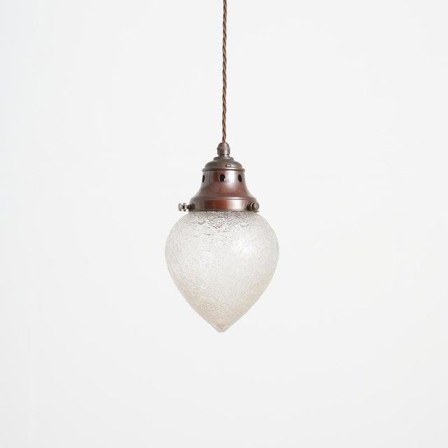 An elegant antique holophane brass pendant light. The light has retained its original dark aged brass gallery , which has...