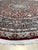 This hand knotted pile rug features a primary color palette of coral, salmon, and pink. Made from wool, this textile...