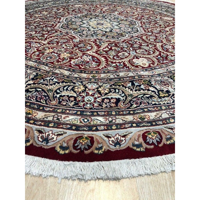 This hand knotted pile rug features a primary color palette of coral, salmon, and pink. Made from wool, this textile...