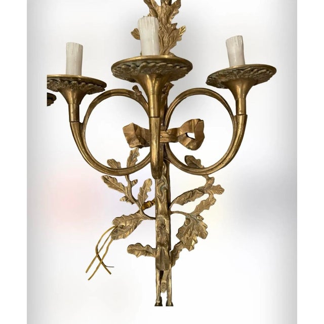 A gorgeous set of heavy Neoclassical French Solid Brass 3 light Wall Sconces finely cast with decorative oak leaves,...
