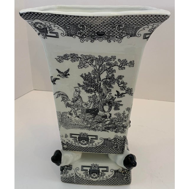 A striking Chinese black and white porcelain vase of square, flaring form, richly decorated with finely detailed figural...