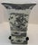A striking Chinese black and white porcelain vase of square, flaring form, richly decorated with finely detailed figural...