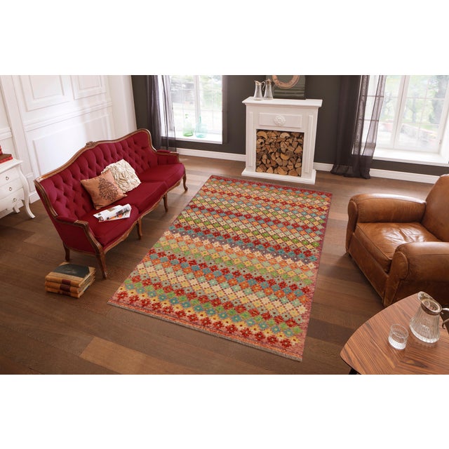 This stunning hand-knotted Afghan Balouchi rug is a captivating addition to any decor. Crafted by skilled artisans, it...