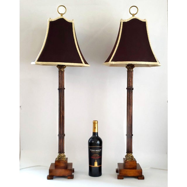 Offering a vintage pair of faux bamboo metal painted candlestick table lamps with shades, circa Late 20th Century. These...