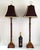 Offering a vintage pair of faux bamboo metal painted candlestick table lamps with shades, circa Late 20th Century. These...