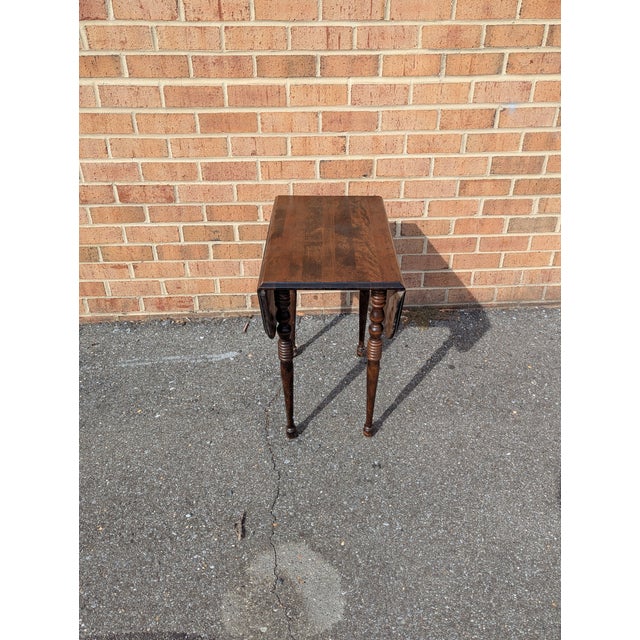 This stunning Vintage Federal Style Drop-Leaf Side Table, dating back to circa 1925, is a rare find for collectors of...