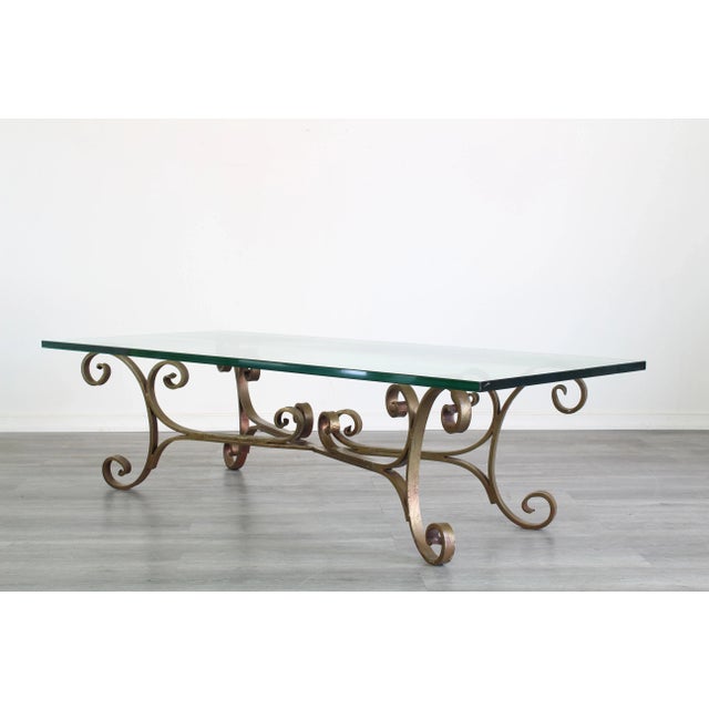 Vintage Solid Iron Hollywood Regency Gilded Coffee Table with Glass Top This table has minor wear Dimensions; 54" Width x...
