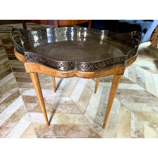 A small elegant drinks, coffee or accent table with a silver plated scalloped shaped, pierced, etched, handled and...