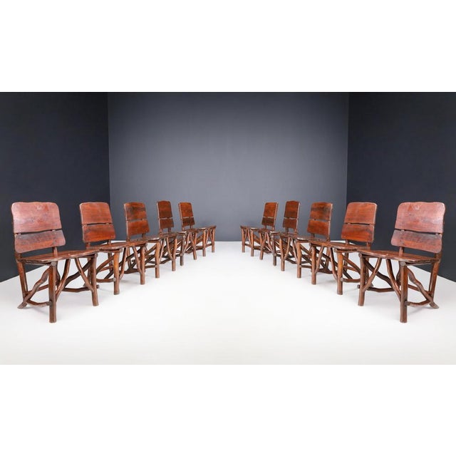 This set of ten dining room chairs, made in France in the 1960s, is a stunning example of brutalist style. Crafted from...