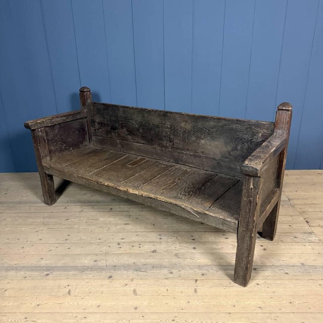 A beautiful rustic Spanish wooden bench from the 18th century. This antique bench is made of elm wood and has been...