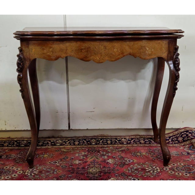 Louis xv style games table in marquetry and mahogany. it features beautiful curves and cabriole legs. the frieze is...