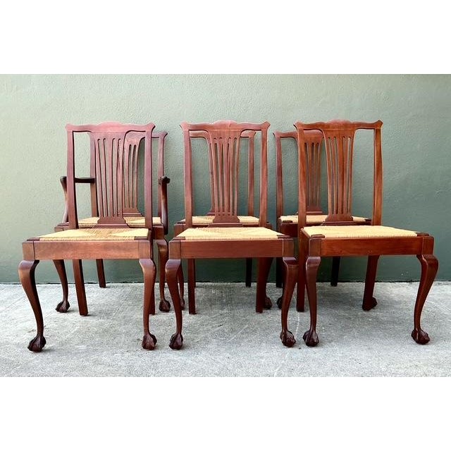This exceptional set of six dining chairs represents a sophisticated fusion of classic 18th-century Chippendale...