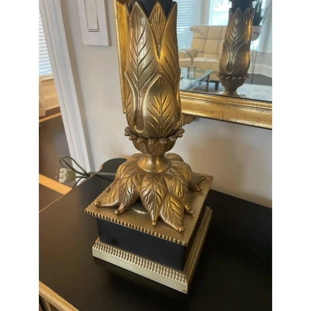 Offered is a regal vintage table lamp by Chapman. This heavy lamp features a black stem and brass accents. Classic and...