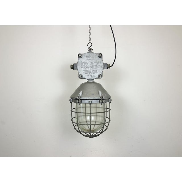 Large industrial factory hanging lamp made by Polam Wilkasy in Poland during the 1970s. It features a cast aluminium body,...