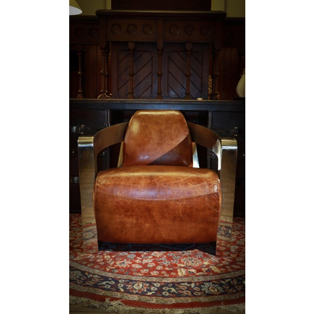 Up for grabs here is a stunning pair of armchairs by timothy oulton halo in chromed steel and leather the larger chair...