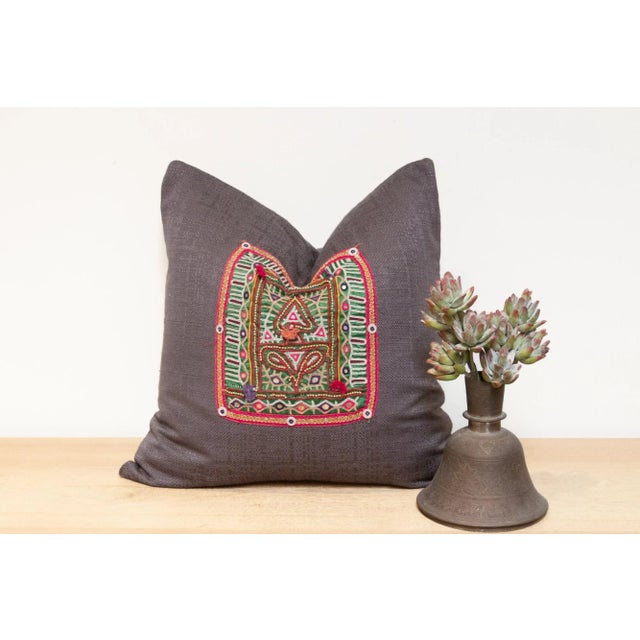 Crafted from fragments of exquisitely hand-embroidered tapestry adorned with intricate open-chain stitch embroidery, this...