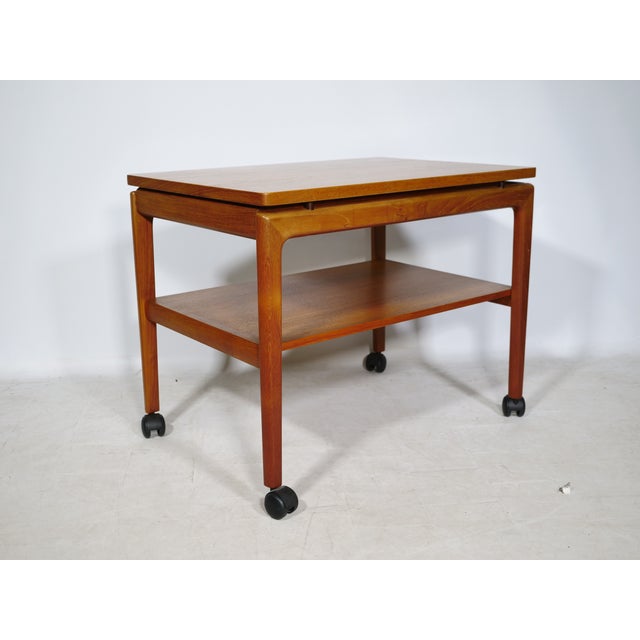 Serving trolley “Senator” by Ole Wanscher for France & Son, 1960s, made of teak. Rectangular top, with a second shelf...