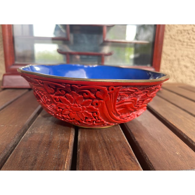 A vintage Chinese carved cinnabar laquerware bowl with relief landscape decoration, probably mid 20th century. Features a...
