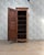 An elegant antique bonnetière dating from the late 19th century, crafted from solid cherry wood. Its slender silhouette...