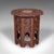 This is a small vintage campaign ornamental table. A Burmese, carved teak fold away display or lamp table, dating to the...