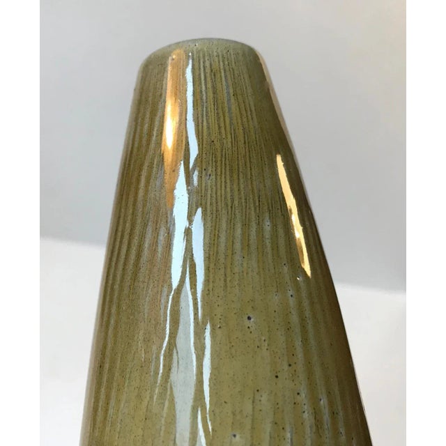 This stoneware vase in olive green glaze was designed by Swedish ceramist Gunnar Nylund and manufactured by Boveskov,...
