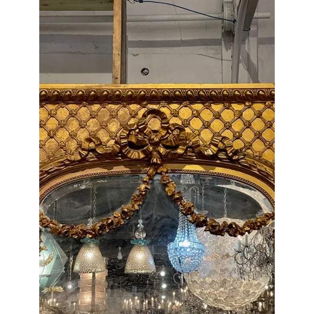 Large 19th century French Louis XVI design carved and giltwood trumeau mirror. Circa 1860. A favorite of top designers!