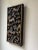 A dramatic and intricately carved wood panel in the Chinese decorative style, featuring expressive Foo dogs (guardian...