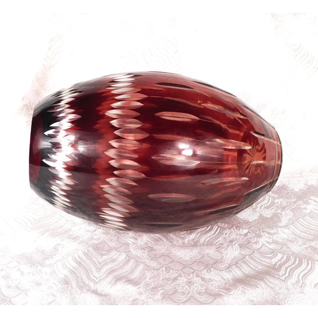 This is a large oval shaped red cut to clear vase. The vase is cut in oval shapes and it has no markings. The vase...