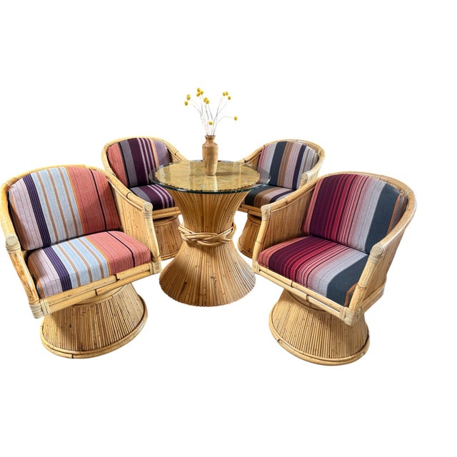 An exceptional and highly collectible set of four McGuire bamboo lounge chairs, each featuring the rare and coveted...