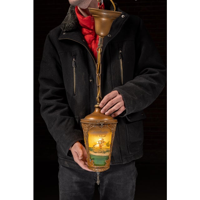Art Nouveau hanging lantern featuring four ribbed-glass panels, each reverse-painted with an idyllic countryside vignette...