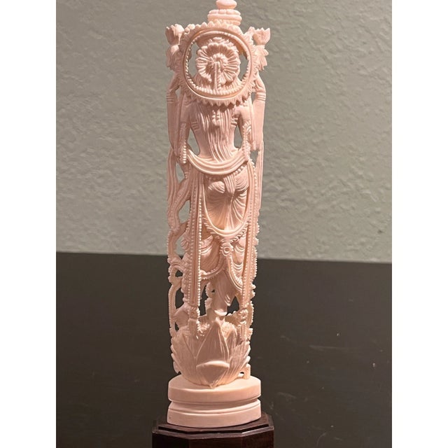 Exquisite 9.5-inch hand-carved bone figurine depicting a multi-armed deity standing atop a detailed lotus base. This...