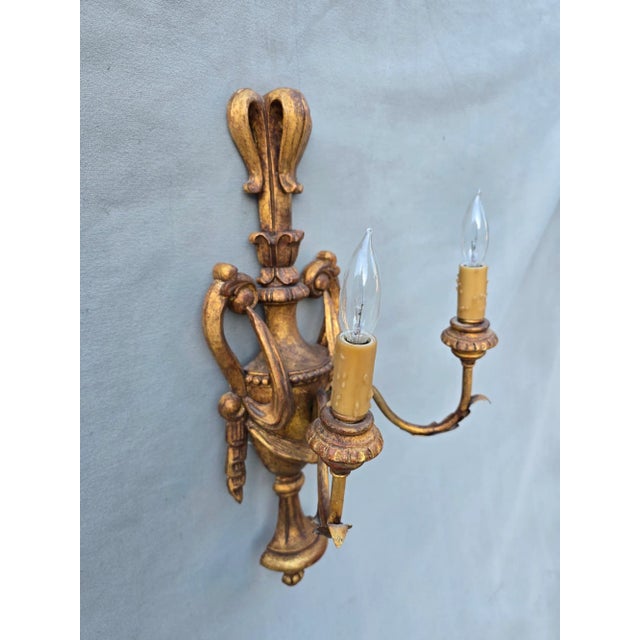 Gilt wood sconce that could be hard wired or used with candles. This is a two arm French style wall sconce. This has no...