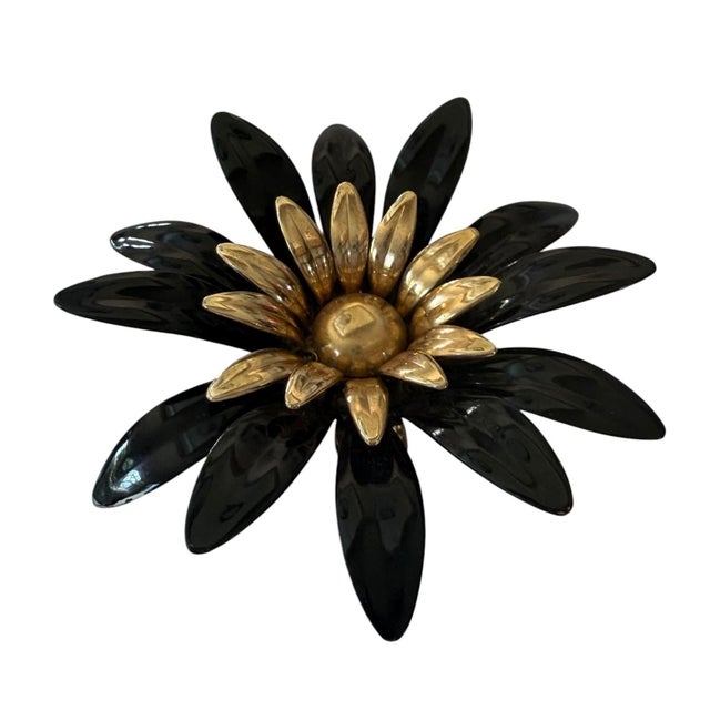 This is a vintage Sarah Coventry "Fashion Petals" flower brooch featuring layered black enamel petals and a gold-tone...