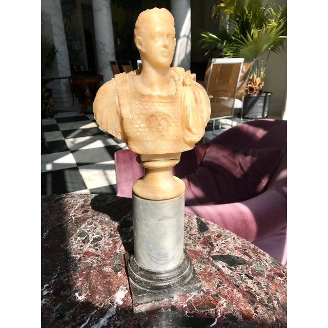 A fine alabaster sculpture of Caesar on a grey marble base.