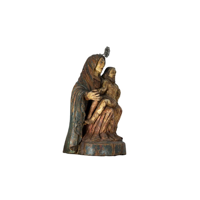An 18th Century Baroque Style figure of the Pietà or the Virgin of Mercy, carved in polychrome wood. Our Lady appears...