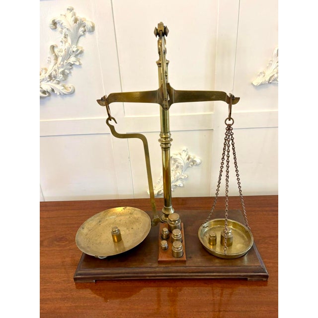 A fine and complete Victorian brass and mahogany apothecary balance scale by the respected makers Day & Millward Limited,...
