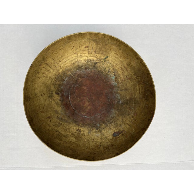 A single round hammered brass offering or incense bowl with Greek key style decoration on interior. .
