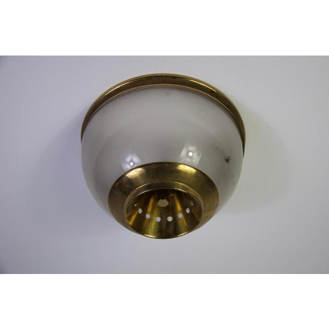 An elegant lsp3 flush mount designed by luigi caccia dominioni for azucena in the 1960s. The lamp features a refined...